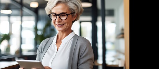 Happy woman employee using tablet at office co working space for business accounting web advertising with empty area