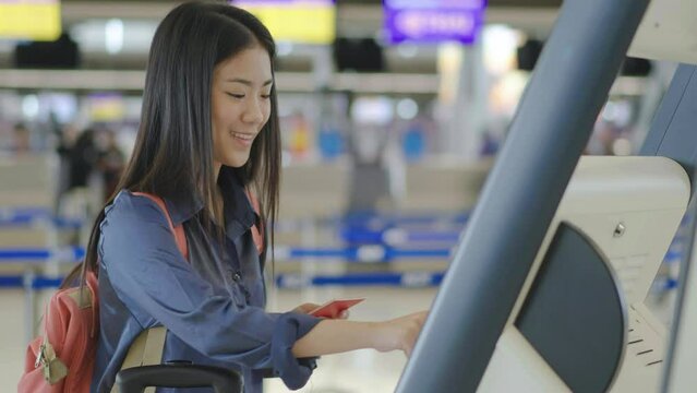 Portrait Happy Traveling Young Beautiful Asian Woman With Passport And Tickets, Check in at counter in the airport terminal, female tourist passenger feel happy and excited to go travel, slow motion