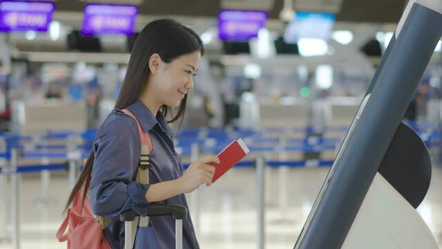 Portrait Of Happy Traveling Young Beautiful Asian Woman With Passport And Tickets, Check in at counter in the airport terminal, female tourist passenger feel happy and excited to go travel 