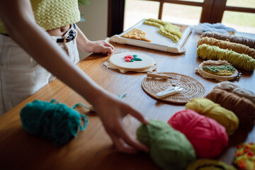 Punch needle. Asian Woman making handmade Hobby knitting in studio workshop. designer workplace Handmade craft project DIY embroidery concept.