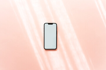 White blank path screen mobile phone with mockup on neutral pink background with shadows.