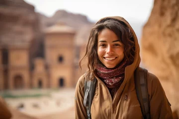 Fototapeten Environmental portrait photography of a happy girl in her 20s wearing a lightweight packable anorak at the petra in maan jordan. With generative AI technology © Markus Schröder