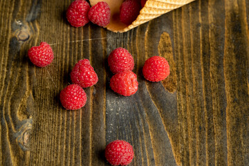 Ripe red raspberries in a crispy waffle cone