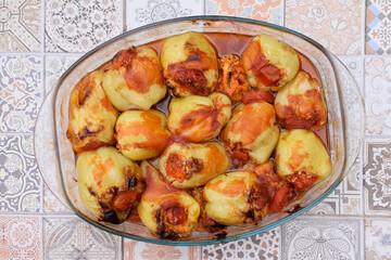 Homemade stuffed peppers. Stuffed paprika in tomato sauce