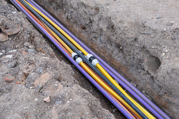 underground electric cable infrastructure communication installation. Construction site with...