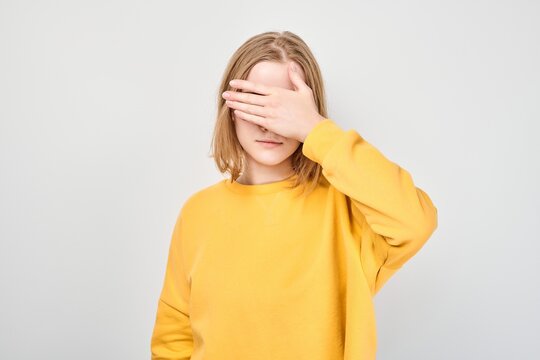 Portrait of disappointed student girl with face palm gesture isolated on white studio background