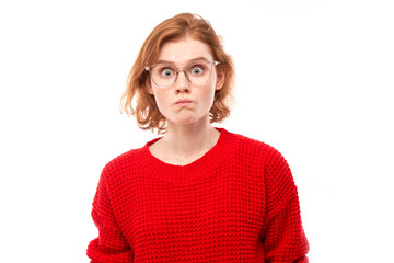 Portrait of surprised young woman with bulging eyes shocked by news, shyly looking at camera isolated over white studio background.