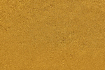 Textured gilded, yellowish wall background. Gold texture for design