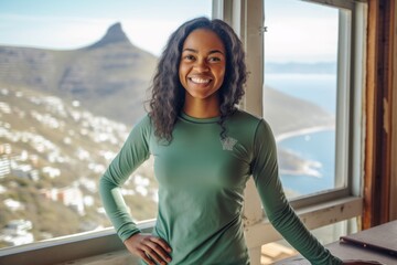 Obraz premium Lifestyle portrait photography of a happy girl in her 30s wearing a long-sleeved thermal undershirt at the table mountain in cape town south africa. With generative AI technology