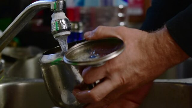 Man's hands close up, washing dishes, home activity