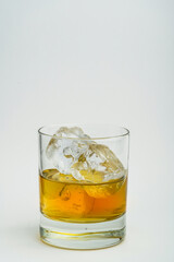 Cocktail whiskey drink on ice isolated at white