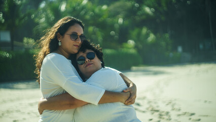 couple of lesbian women on the beach, dressed in white, lgbtqia+ representation, love between women