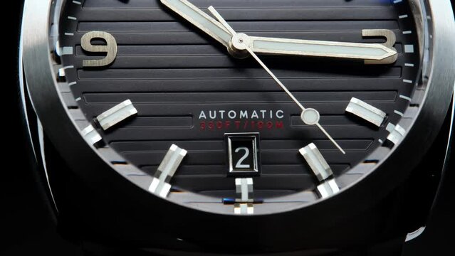Stylish Luxury Man Wrist Watch With Moving Hand And Multiple Dials. Men's watch in metal with sapphire crystal. Closeup view of rotating watch, running second arrow. Cyclops watch