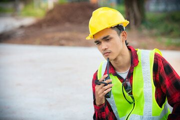 Engineer wearing a yellow hat Thinking about analyzing work