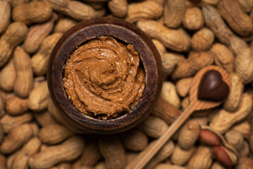 Peanut butter in a jar and peanuts in the shell