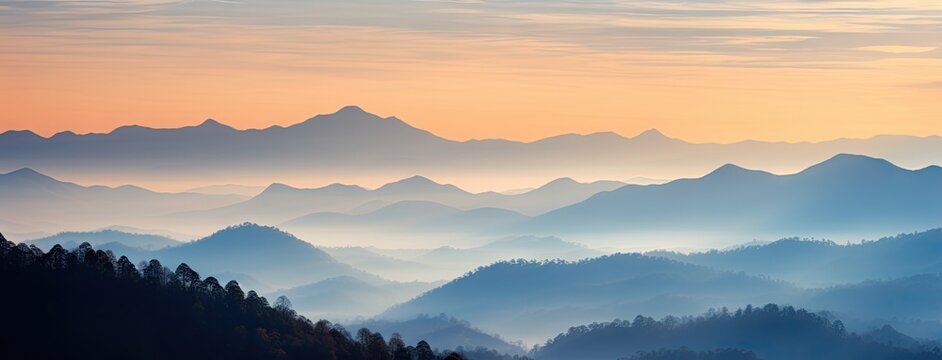 A stunning mountain range illuminated by the warm colors of a breathtaking sunset