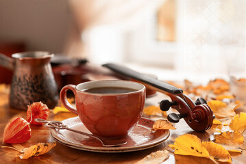 Cozy autumn photo with a cup of coffee and a violin