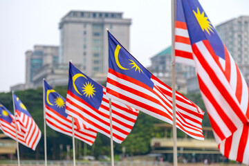 The Malaysia flag is also known as Jalur Gemilang waving with a city in the background....