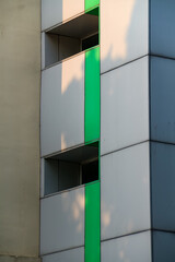 Facade of a modern office building with green and white walls.