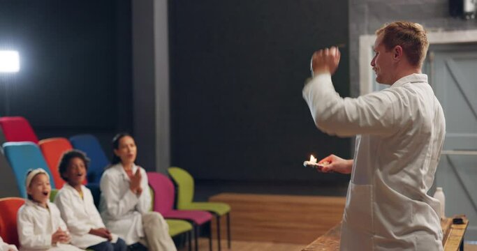 Science, man and fire with children and teacher for education, learning and an exhibition. Chemistry, school and a male scientist with a flame, innovation and teaching physics to students at a museum