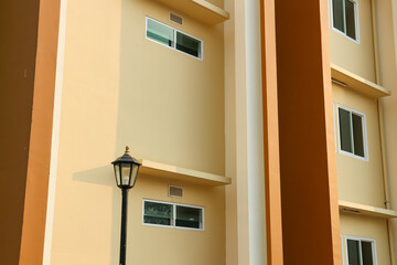 Modern apartment building exterior with street lamp, close-up of photo