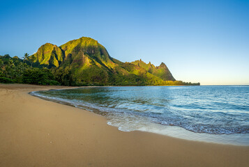 Aerial panoramic image of early morning light just catching the mountains. Tunnels beach on Hawaiian island of Kauai - Powered by Adobe