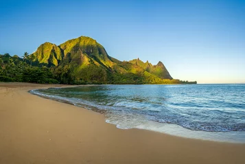 Tuinposter Aerial panoramic image of early morning light just catching the mountains. Tunnels beach on Hawaiian island of Kauai © steheap