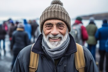 Close-up portrait photography of a happy old man wearing a trendy beanie at the blue lagoon in reykjavik iceland. With generative AI technology - obrazy, fototapety, plakaty