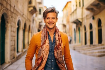 Lifestyle portrait photography of a joyful boy in his 30s wearing a gorgeous silk scarf at the dubrovnik old town in dubrovnik croatia. With generative AI technology