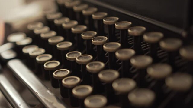 4k close-up of a person typing on a vintage typewriter. Person pressing keys on an old typewriter. 