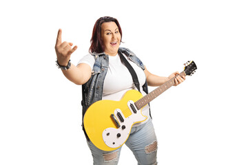 Corpulent young female with an electric guitar gesturing rock and roll sign