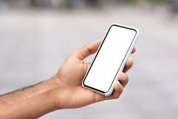 Unrecognizable man hand holding phone with white blank screen