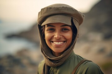 Close-up portrait photography of a happy girl in his 30s wearing a sophisticated pillbox hat at the socotra island in yemen. With generative AI technology