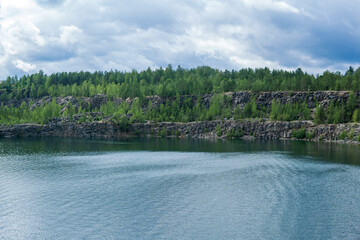 landscape with a clear lake on the site of an old stone quarry