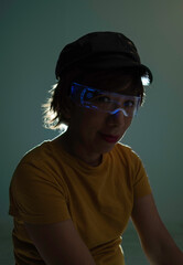 Woman in the dark with luminous glasses