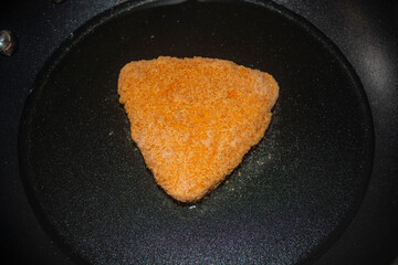 One piece of french fries is fried in a frying pan with olia. Fried cheese