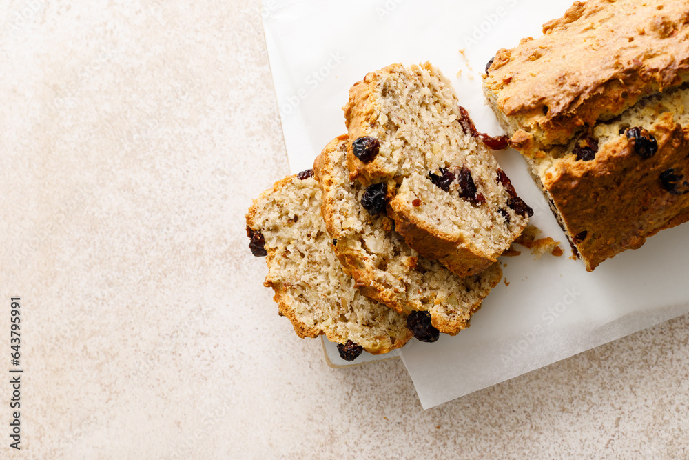 Wall mural fruitcake with cranberry, almond and pecan nuts sliced on a wooden board