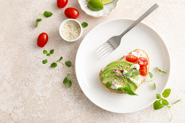 Avocado toast with cheese cottage, tomato and herbs for breakfast