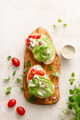 Avocado toast with cheese cottage, tomato and herbs for breakfast