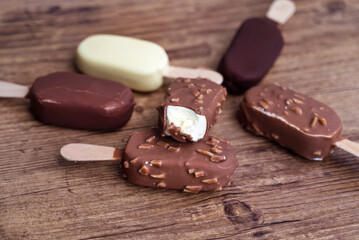 Ice cream vanilla sticks with chocolate and almonds
