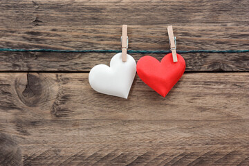 Fototapeta premium Loving fabric hearts on wooden background, perfect for Valentine's Day