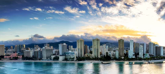Poster Panorama of world famous Waikiki and its famous beach front at sunrise with clouds over the Koolau Mountains © Allen.G