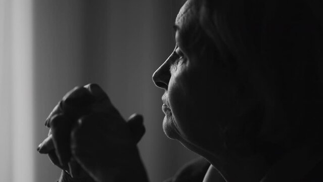 Monochromatic Pensive senior woman in deep mental reflection, black and white. Thoughtful expression of 70s person depicting old age and wisdom