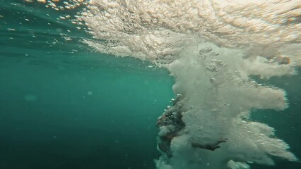 One young happy attractive girl running and jumping in to the water of the blue ocean sea enjoying and having fun on vacations time carefree concept lifestyle. Beautiful woman at the beach. 
