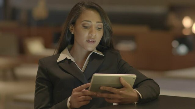 Confident Woman Browsing the Web Internet on Mobile Tablet Device