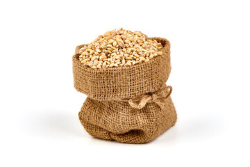 Pearl barley in rustic burlap, isolated on white background.