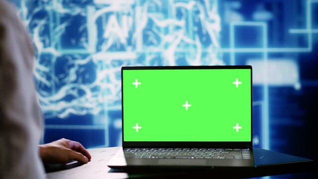 Computer scientist using green screen laptop to implement artificial intelligence parallel processing. Manager overseeing chroma key device enabling AI systems to do machine learning inference