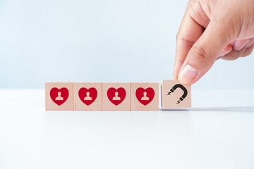 Wooden cube blocks with red hearts and customer loyalty icon on background. Building relationships,...
