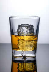 glass of whiskey with ice cubes