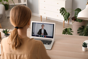 Young woman having job interview online at home